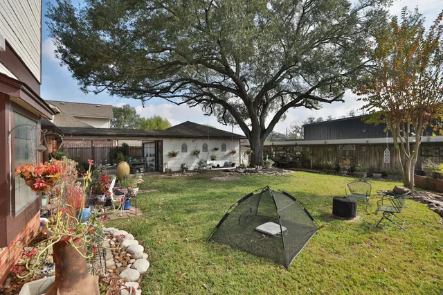 a view of a house with a yard patio and fire pit