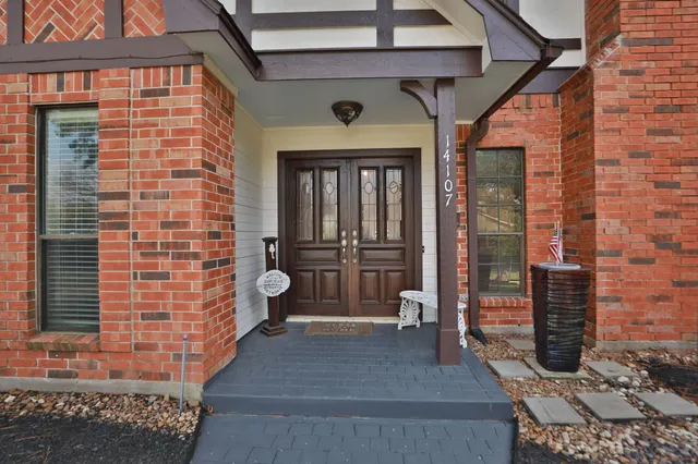 a view of a porch with a table and chairs