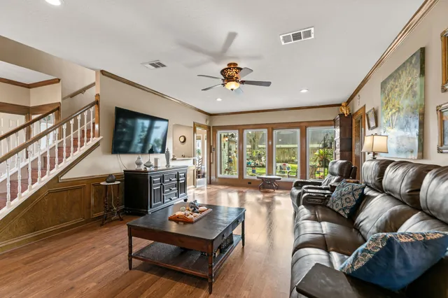 a living room with fireplace furniture and a flat screen tv