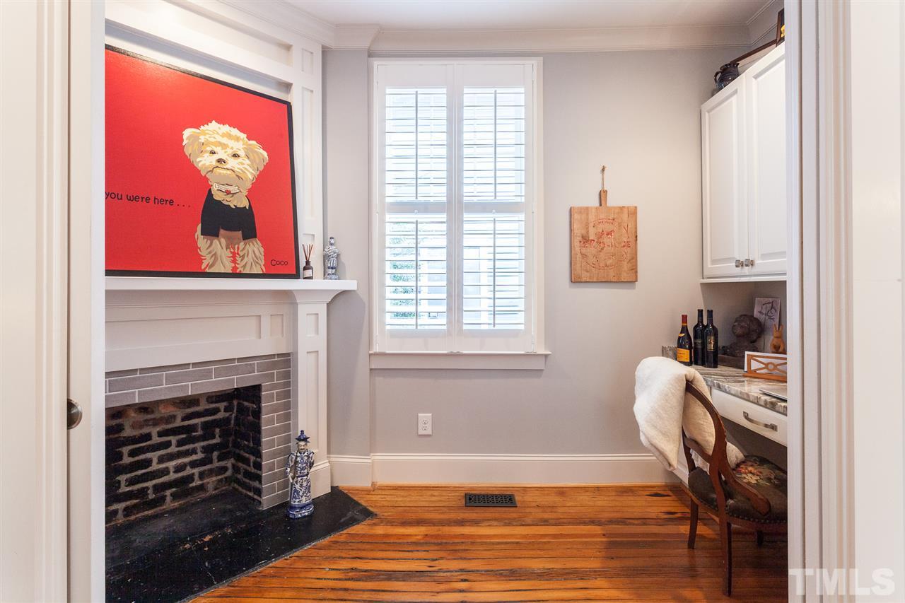 507 Adams Street Raleigh, NC 27605 - Photo 13 of 30 a living room with furniture a fireplace and a window