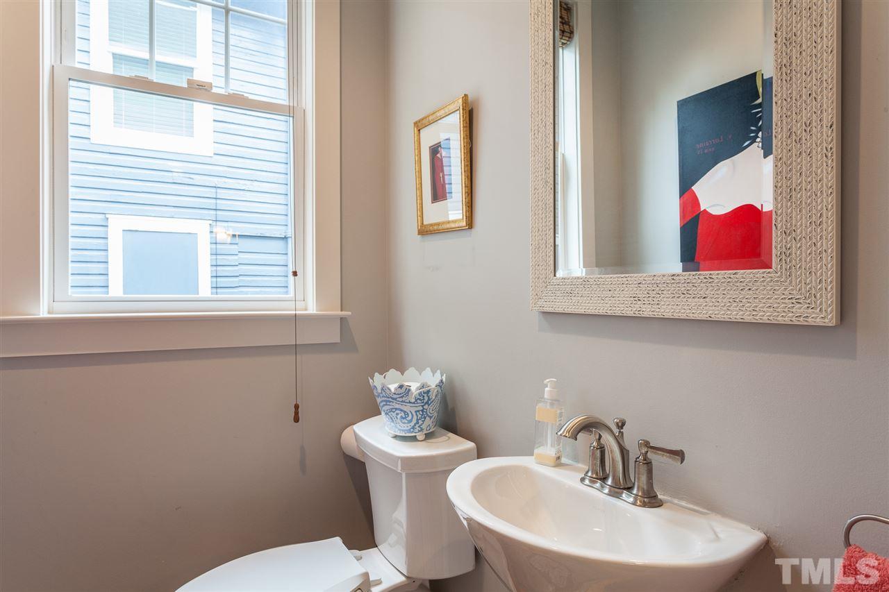 507 Adams Street Raleigh, NC 27605 - Photo 15 of 30 a bathroom with a toilet sink and mirror