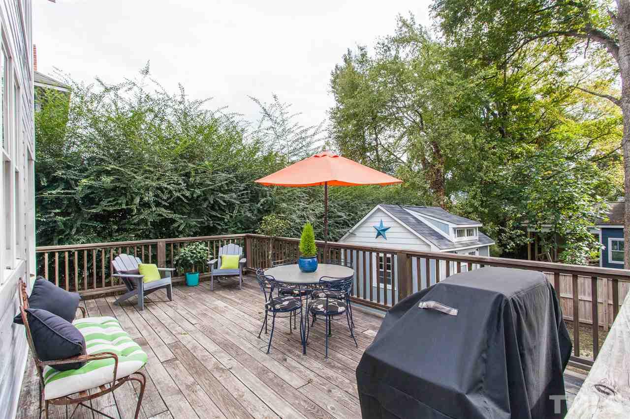 507 Adams Street Raleigh, NC 27605 - Photo 22 of 30 a balcony with wooden floor table and chairs