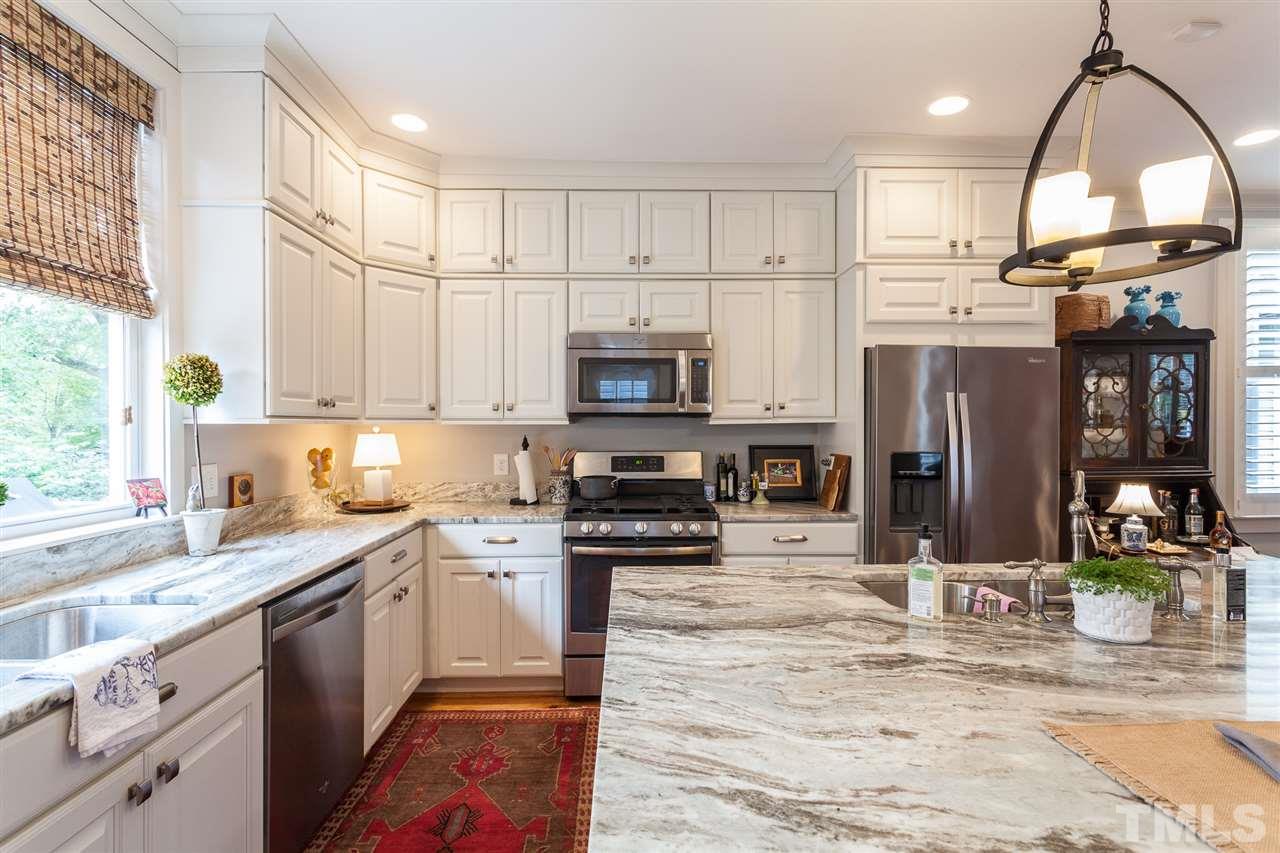 507 Adams Street Raleigh, NC 27605 - Photo 5 of 30 a kitchen with stainless steel appliances granite countertop a stove a sink and a microwave