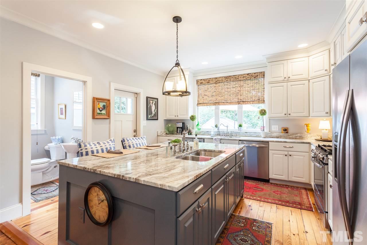 507 Adams Street Raleigh, NC 27605 - Photo 6 of 30 a kitchen with granite countertop a sink stove and cabinets