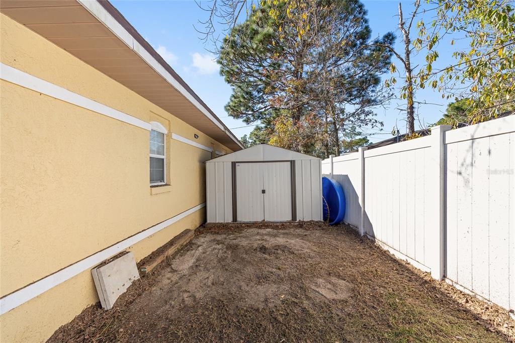 14 Bahia Trace Loop Ocala, FL 34472 - Photo 11 of 46 a view of a house with a large window and wooden fence