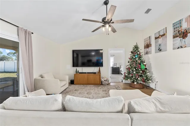a living room with furniture and a flat screen tv