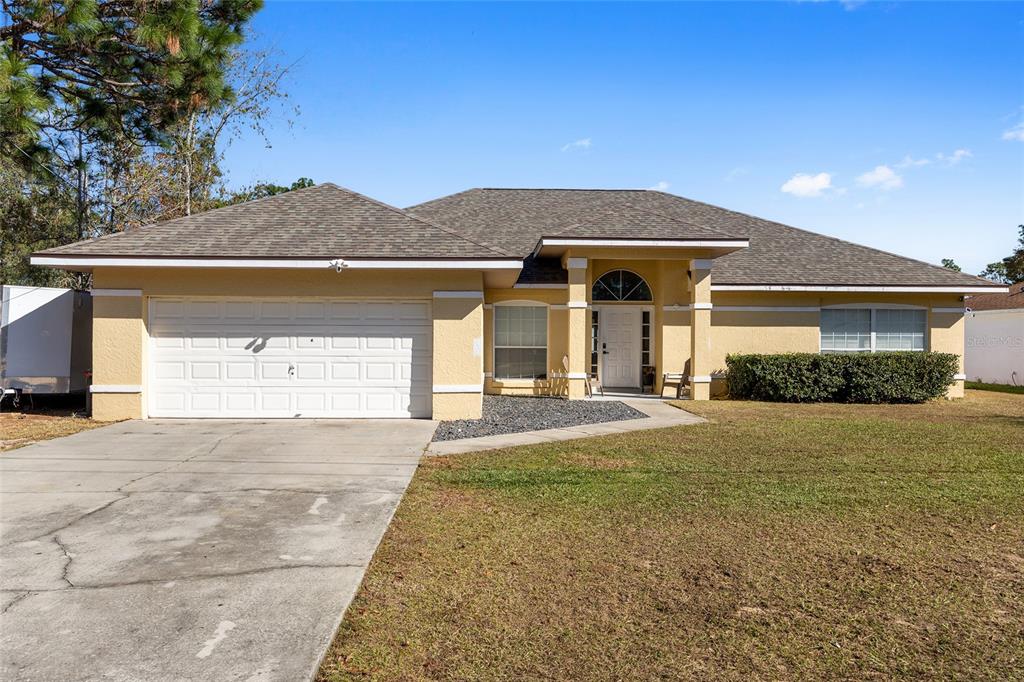 14 Bahia Trace Loop Ocala, FL 34472 - Photo 2 of 46 a front view of a house with a yard and garage
