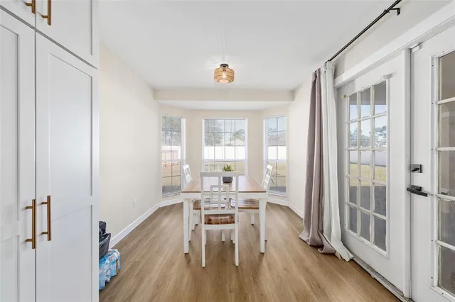 a workspace with wooden floor and windows
