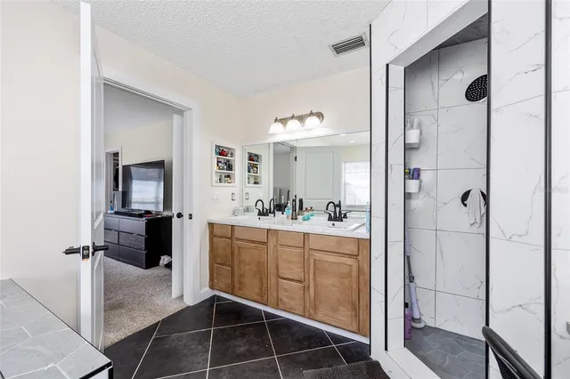 a bathroom with a double vanity sink and mirror