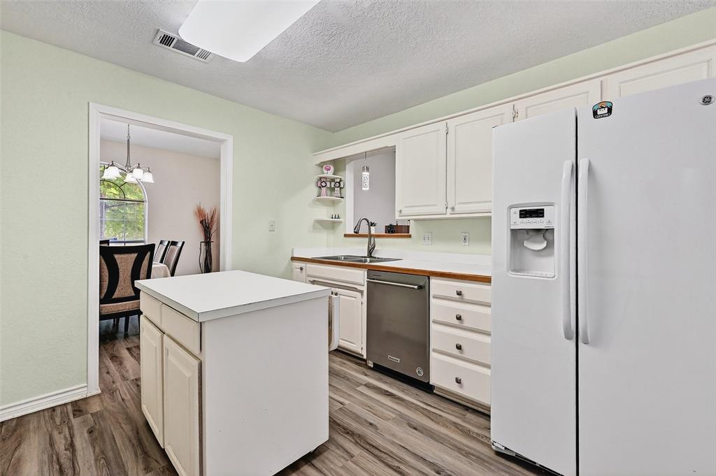 2107 Meadows Circle Sherman, TX 75092 - Photo 11 of 36 a kitchen with white cabinets and white appliances