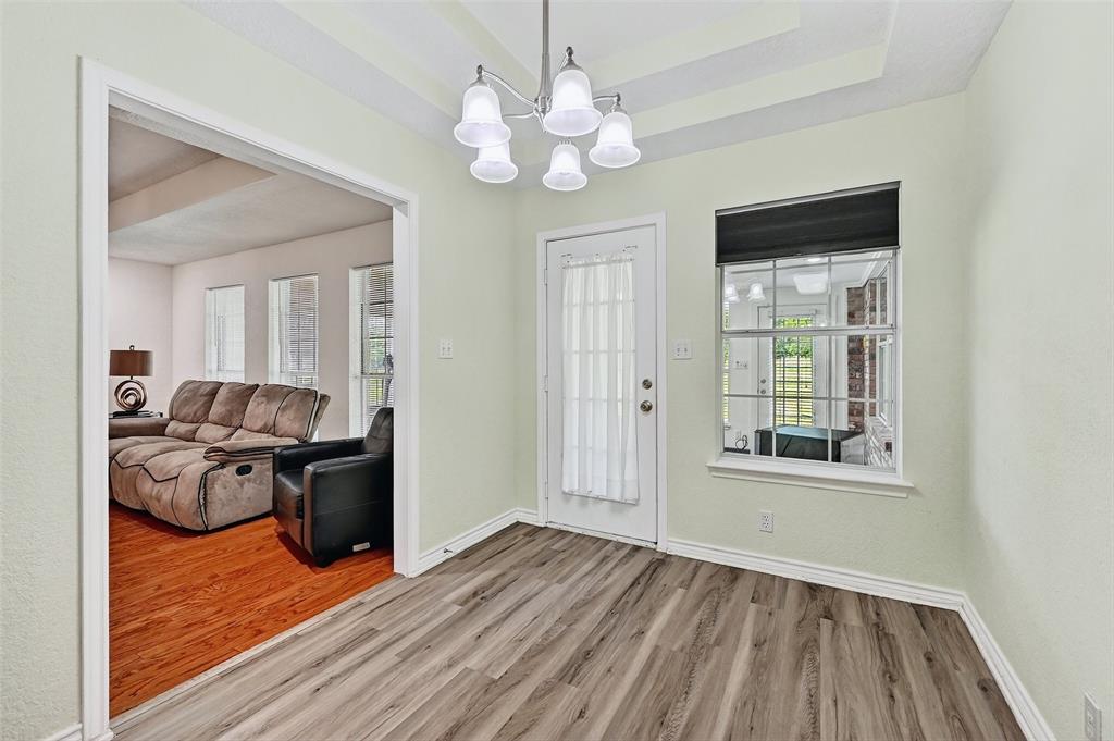 2107 Meadows Circle Sherman, TX 75092 - Photo 14 of 36 a view of a livingroom with furniture wooden floor a chandelier