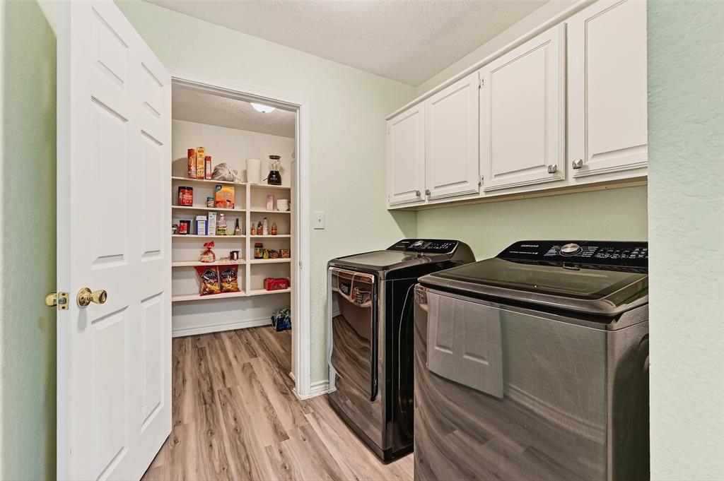 2107 Meadows Circle Sherman, TX 75092 - Photo 15 of 36 a utility room with cabinets washer and dryer