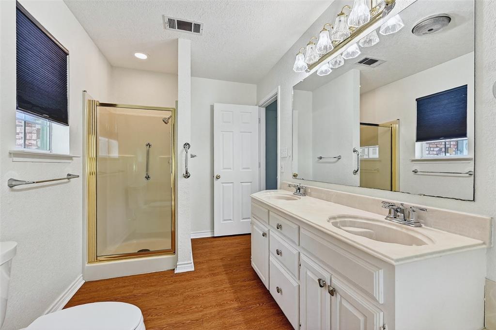 2107 Meadows Circle Sherman, TX 75092 - Photo 20 of 36 a spacious bathroom with a shower sink double and mirror