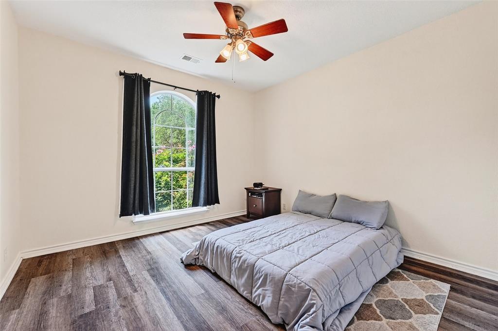 2107 Meadows Circle Sherman, TX 75092 - Photo 22 of 36 a bedroom with a large bed and a large window