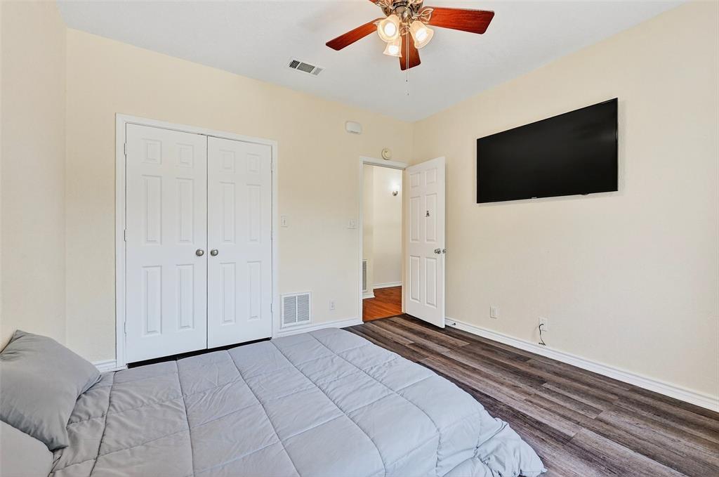2107 Meadows Circle Sherman, TX 75092 - Photo 23 of 36 a bedroom with a bed and a flat screen tv