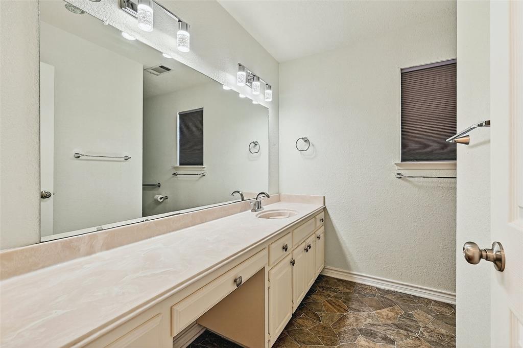 2107 Meadows Circle Sherman, TX 75092 - Photo 24 of 36 a bathroom with a sink and a mirror