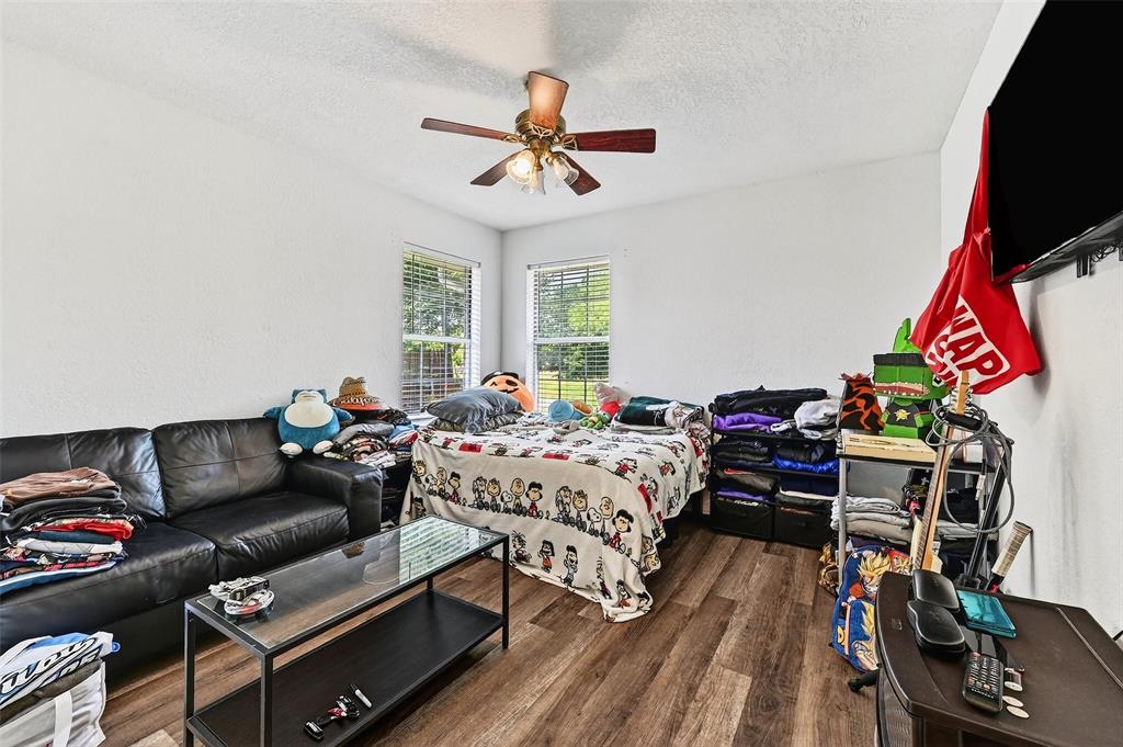2107 Meadows Circle Sherman, TX 75092 - Photo 26 of 36 a bedroom with furniture and a flat screen tv