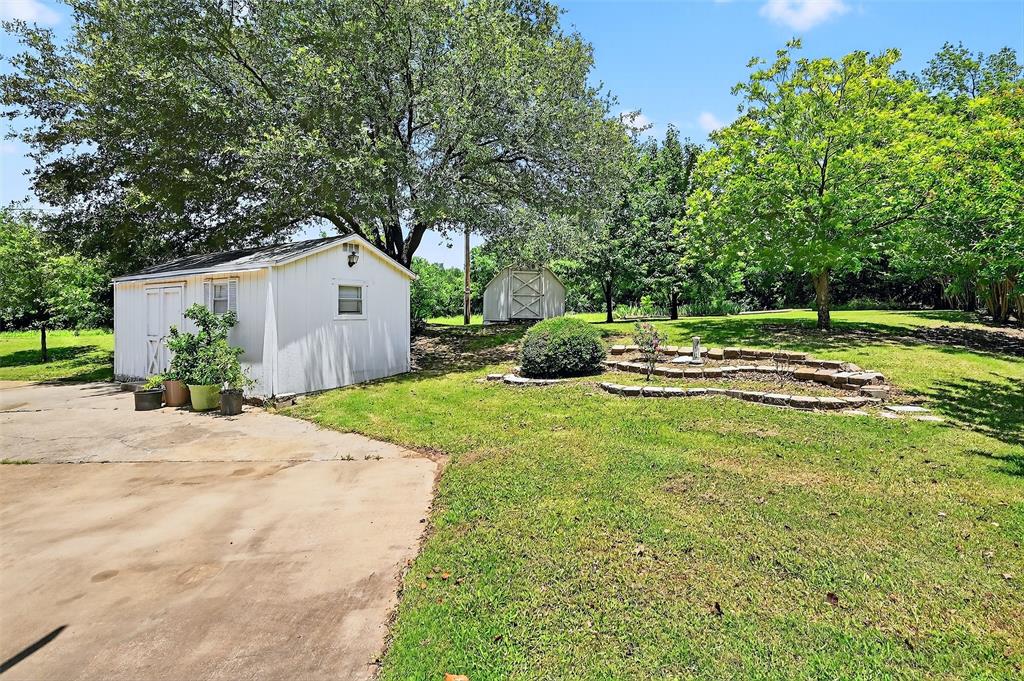 2107 Meadows Circle Sherman, TX 75092 - Photo 28 of 36 a house with a yard and a large tree