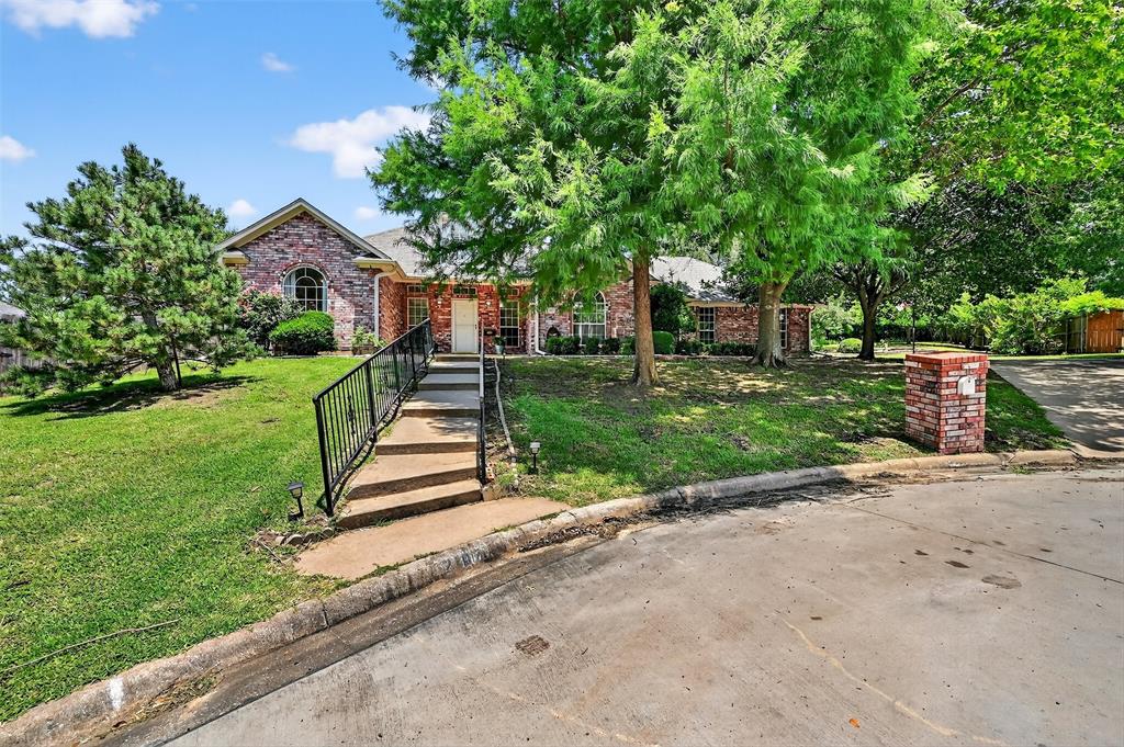 2107 Meadows Circle Sherman, TX 75092 - Photo 32 of 36 a front view of a house with a yard and an outdoor space