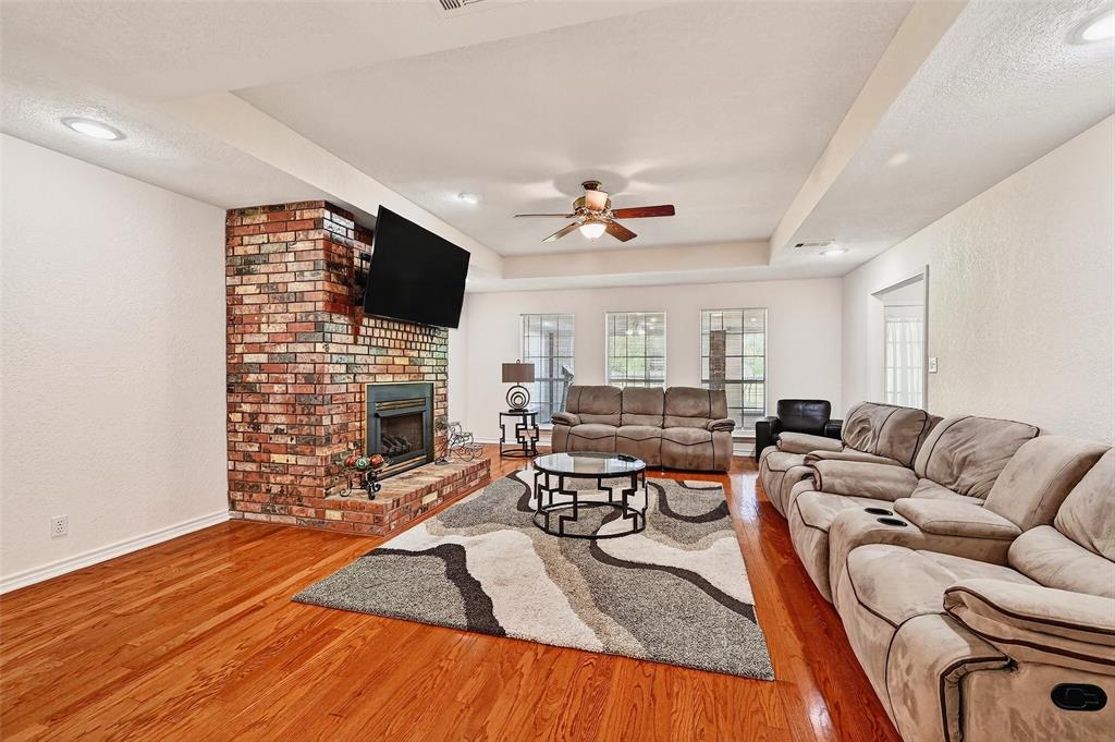2107 Meadows Circle Sherman, TX 75092 - Photo 6 of 36 a living room with furniture wooden floor and a flat screen tv