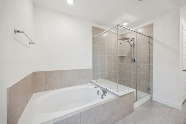 a bathroom with a bathtub and shower