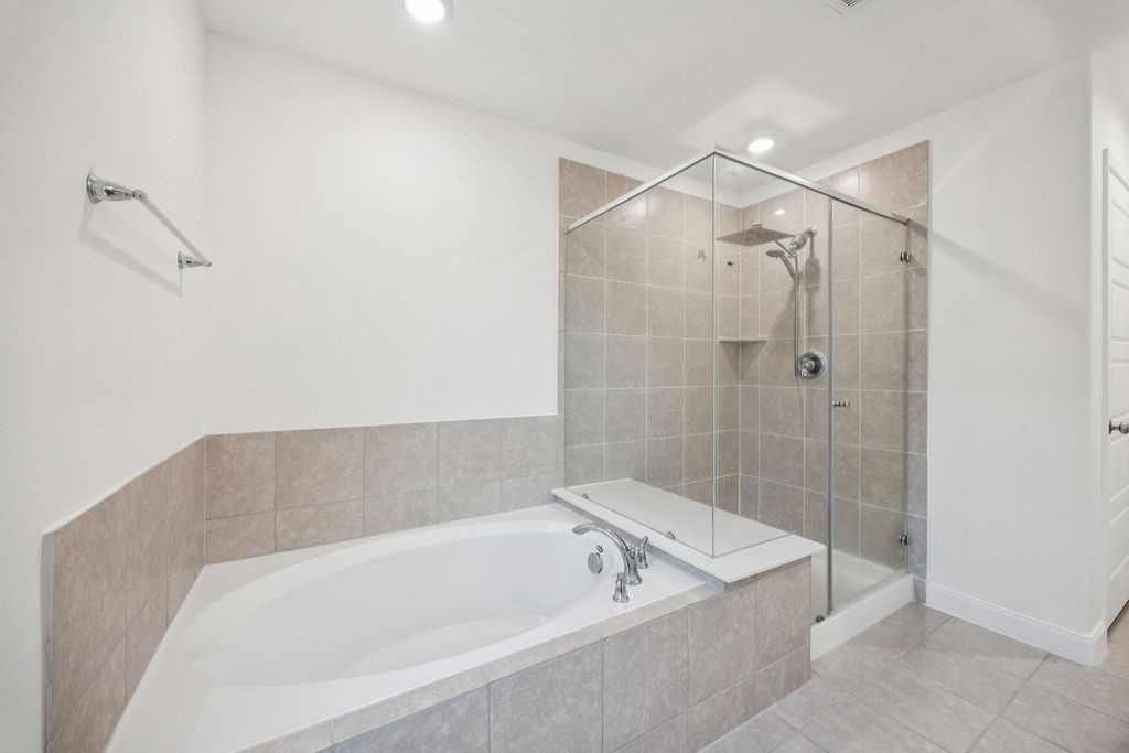 4431 Upland Stream Lane Katy, TX 77493 - Photo 13 of 17 a bathroom with a bathtub and shower