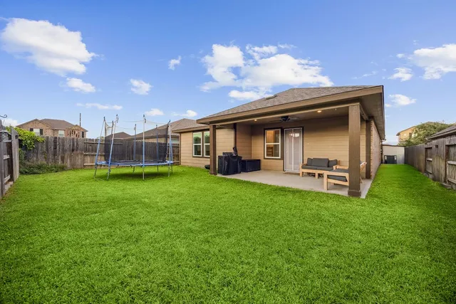 a view of a house with backyard and porch