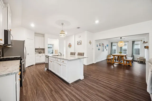 a open kitchen with sink cabinets and wooden floor