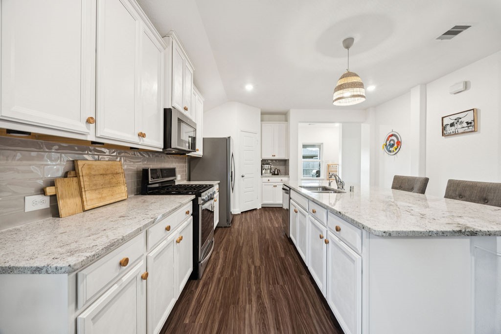 4431 Upland Stream Lane Katy, TX 77493 - Photo 6 of 17 a large kitchen with stainless steel appliances granite countertop a lot of counter space and wooden floors