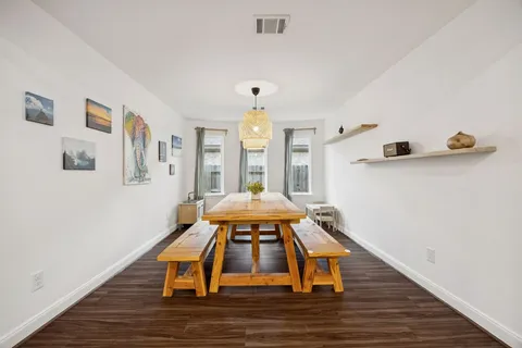a room with wooden floor and white walls
