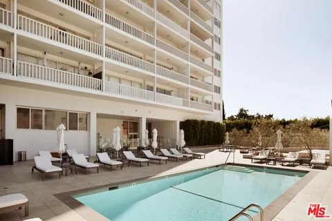 a view of a swimming pool with outdoor seating