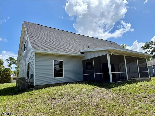 a view of a house with a window and yard
