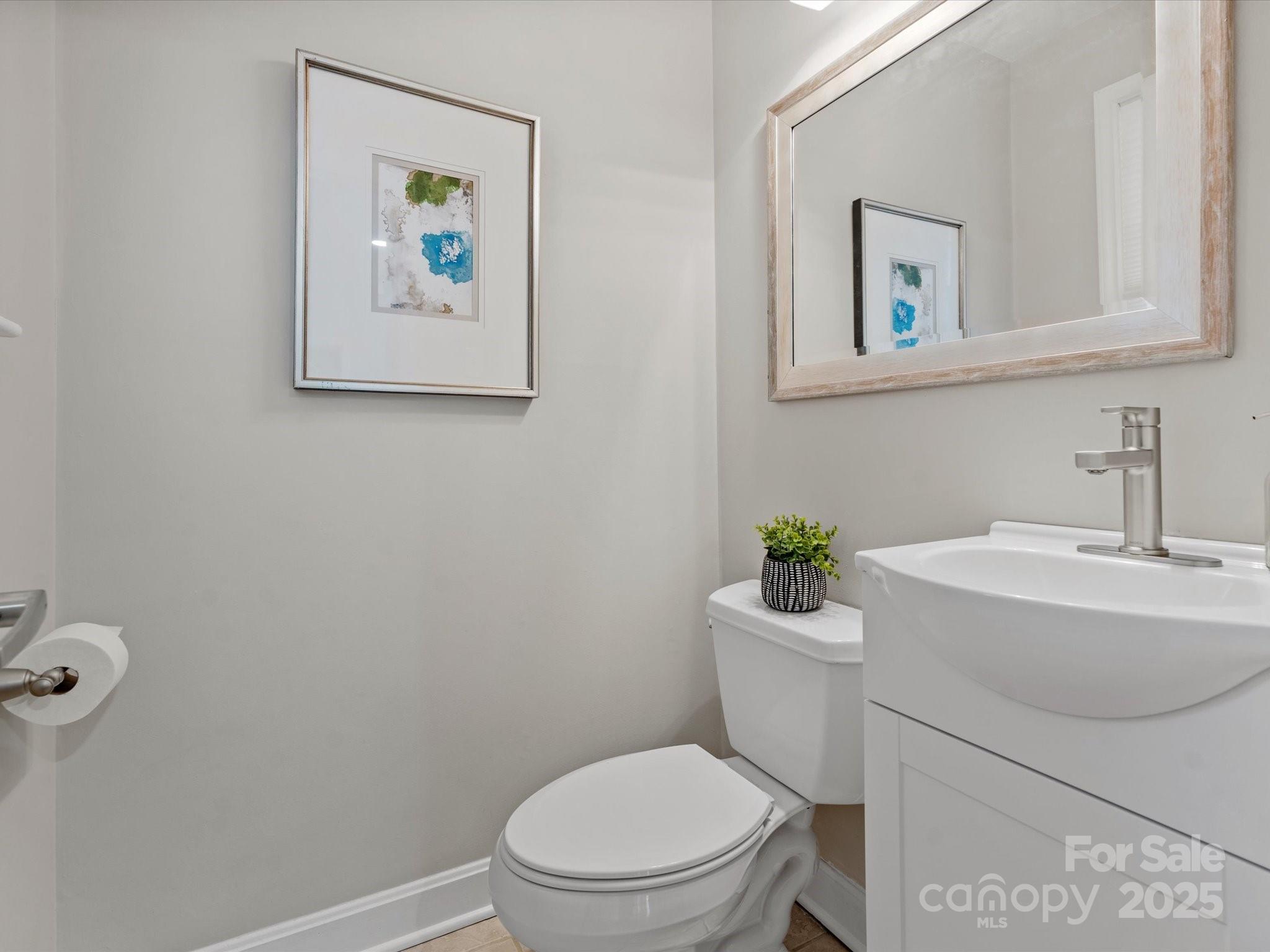 122 Lansdowne Road Charlotte, NC 28270 - Photo 12 of 21 a white toilet sitting next to a bathroom sink