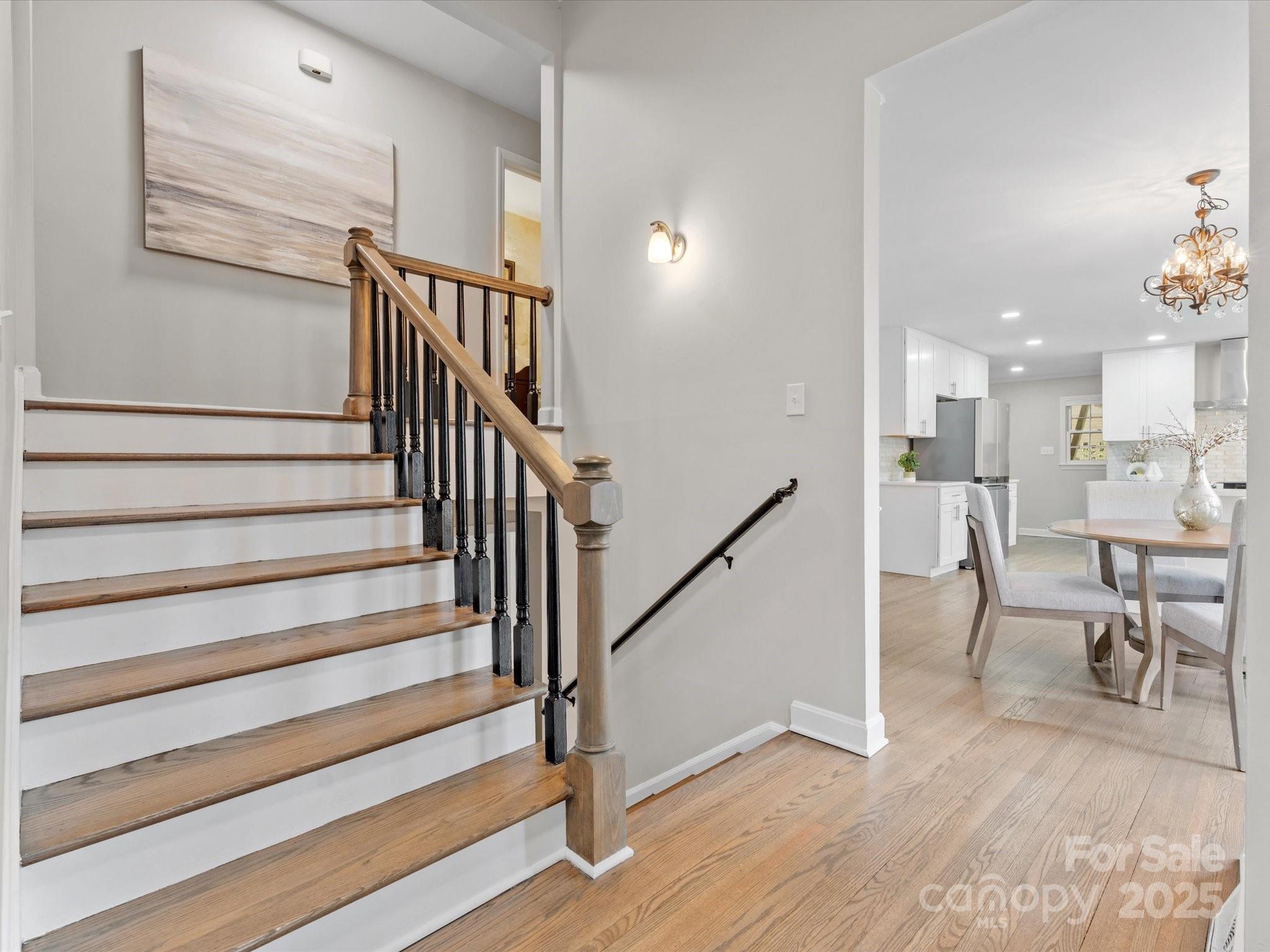 122 Lansdowne Road Charlotte, NC 28270 - Photo 14 of 21 a view of staircase and dining room with wooden floor