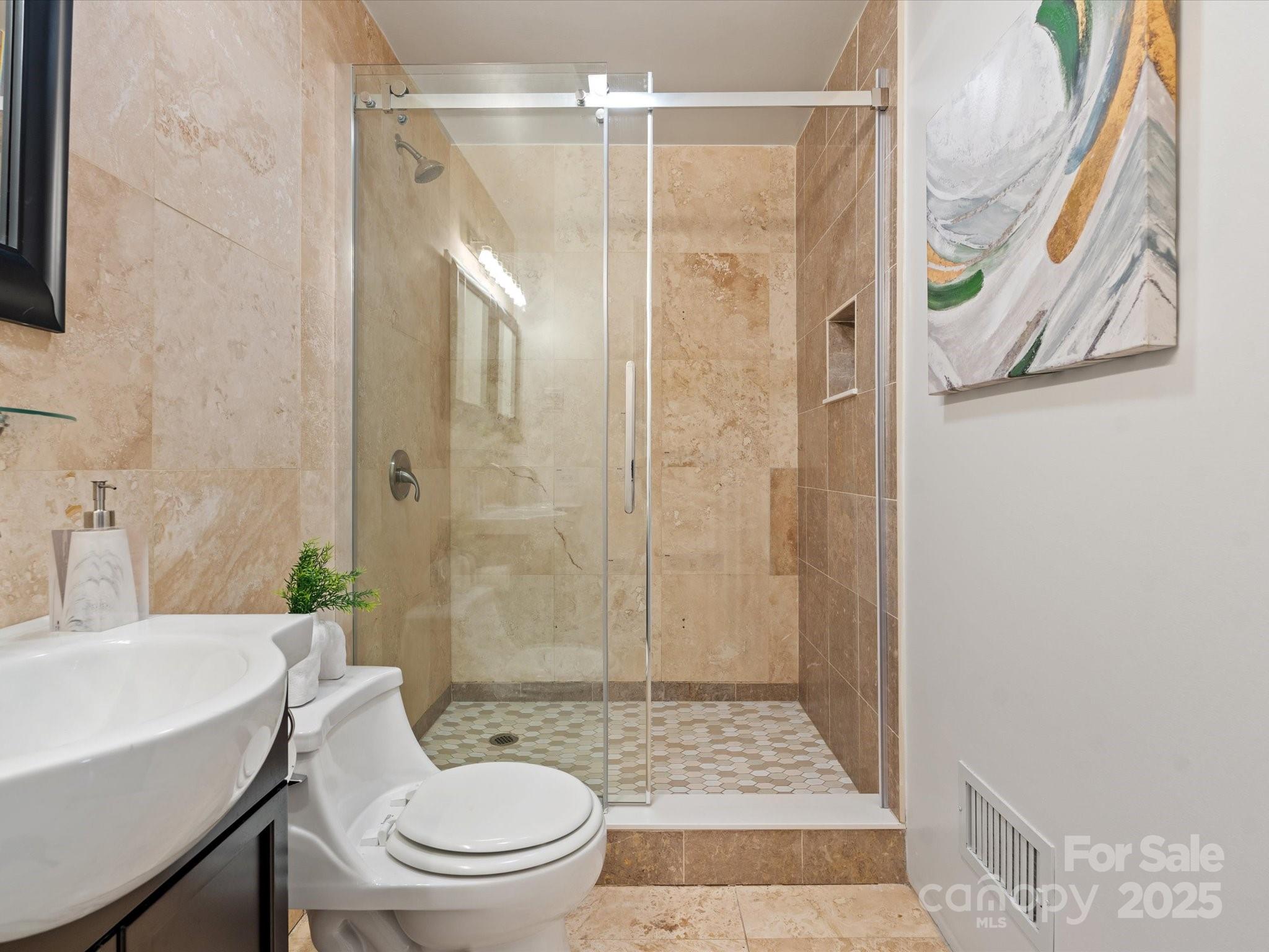 122 Lansdowne Road Charlotte, NC 28270 - Photo 16 of 21 a bathroom with a sink a toilet and shower