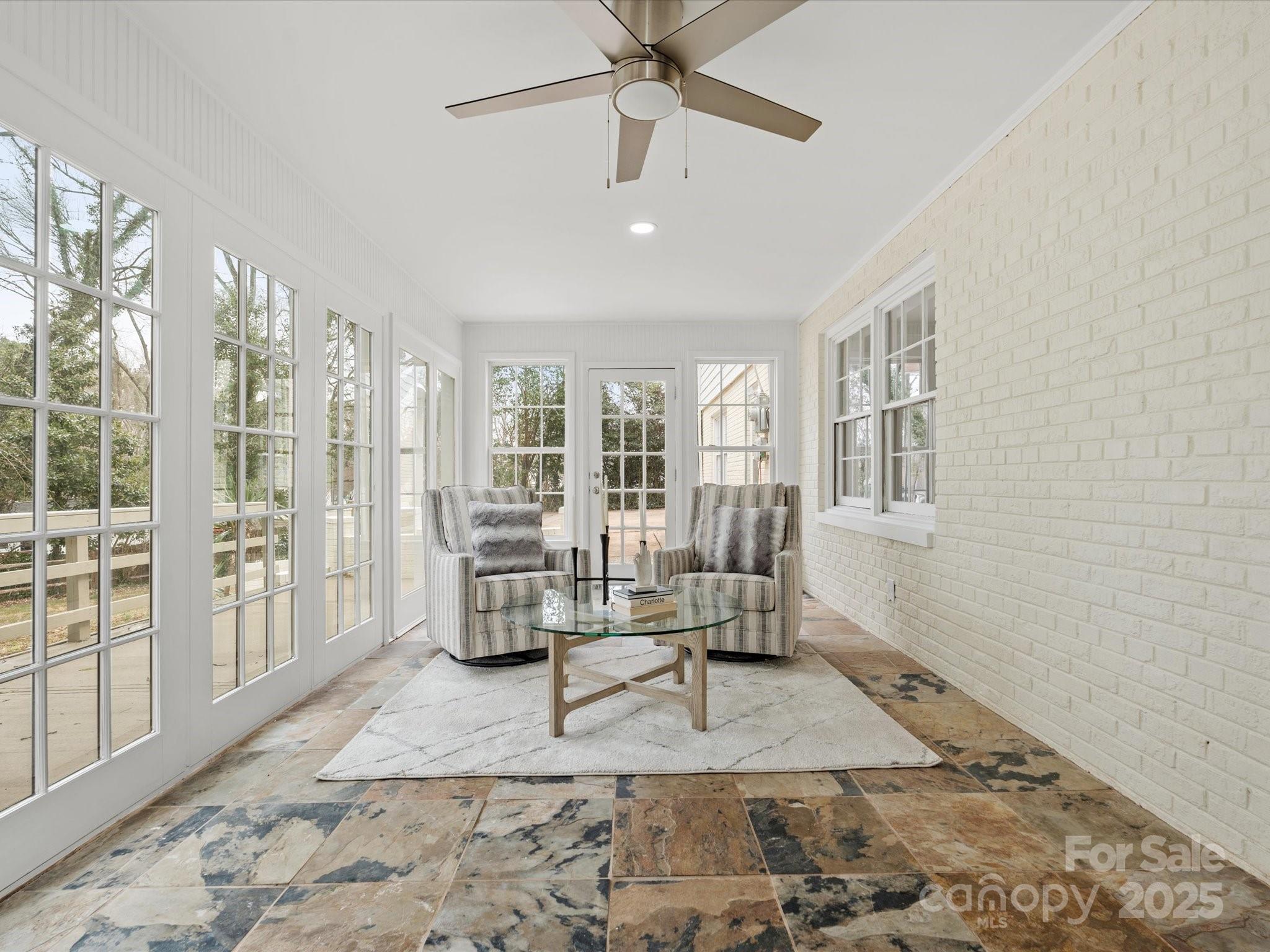 122 Lansdowne Road Charlotte, NC 28270 - Photo 10 of 21 a living room with furniture and a floor to ceiling window