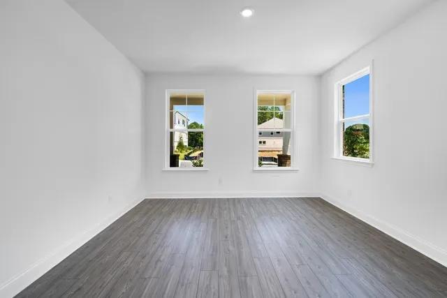 a view of an empty room with a fireplace and a window