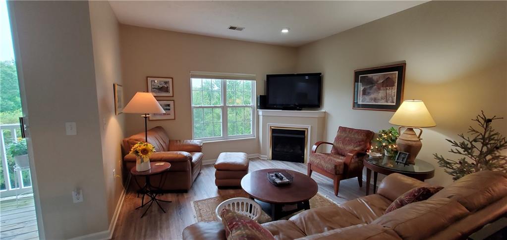 216 Stockton Ridge Cranberry Township, PA 16066 - Photo 5 of 25 a living room with furniture a fireplace and a flat screen tv