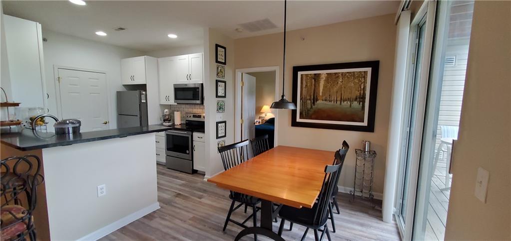 216 Stockton Ridge Cranberry Township, PA 16066 - Photo 10 of 25 a kitchen with stainless steel appliances refrigerator wooden floor dining table and chairs