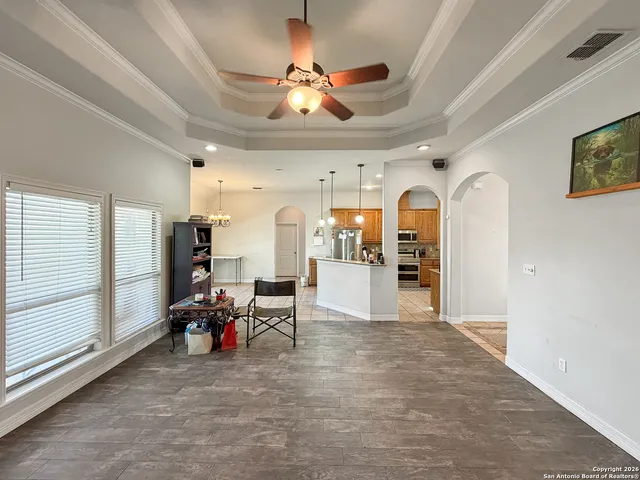a view of a livingroom with furniture and a ceiling fan