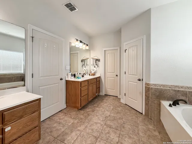 a room with a bed and a dresser