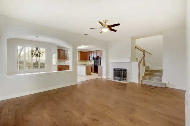a view of an empty room with a fireplace and a window