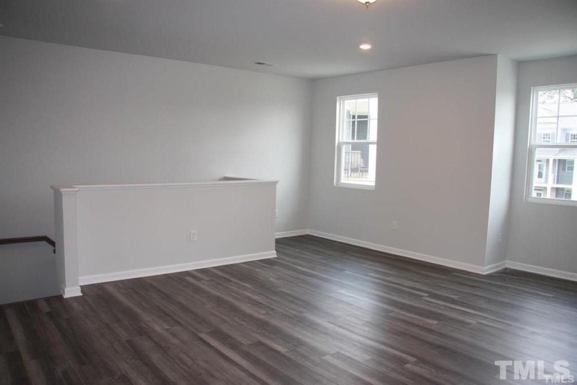 2919 Sunflower Road Apex, NC 27502 - Photo 10 of 34 an empty room with wooden floor and windows