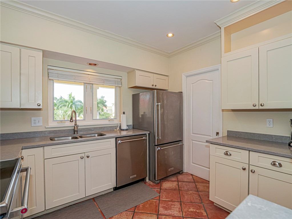5060 Harmony Circle, Unit 304 Vero Beach, FL 32967 - Photo 12 of 36 a kitchen with a sink appliances and cabinets