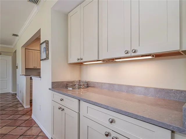 a kitchen with stainless steel appliances white cabinets and a sink