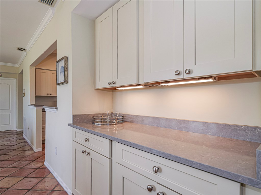 5060 Harmony Circle, Unit 304 Vero Beach, FL 32967 - Photo 15 of 36 a kitchen with stainless steel appliances white cabinets and a sink