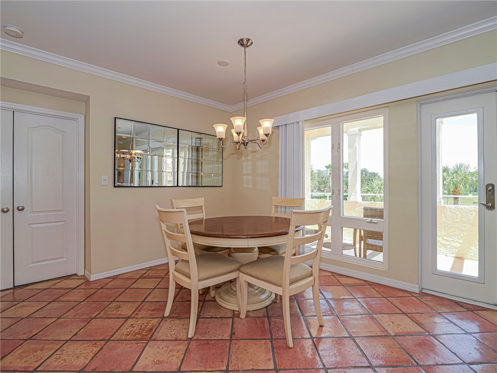 5060 Harmony Circle, Unit 304 Vero Beach, FL 32967 - Photo 17 of 36 a dining room with furniture and window