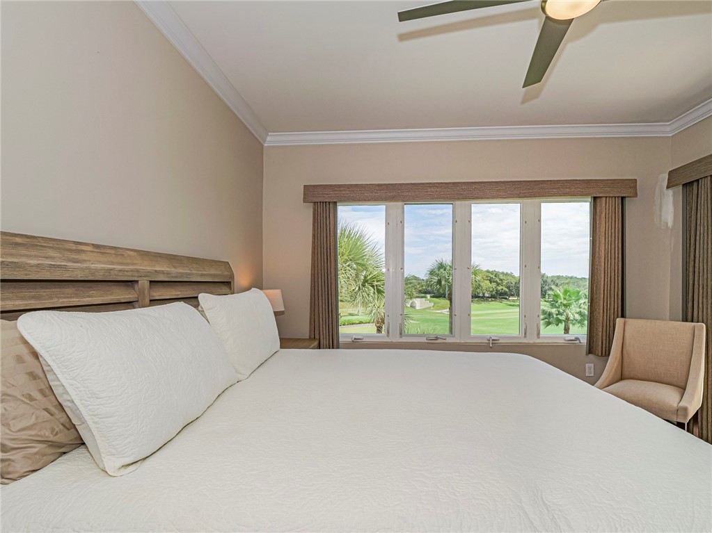 5060 Harmony Circle, Unit 304 Vero Beach, FL 32967 - Photo 19 of 36 a bed sitting in a bedroom next to a window