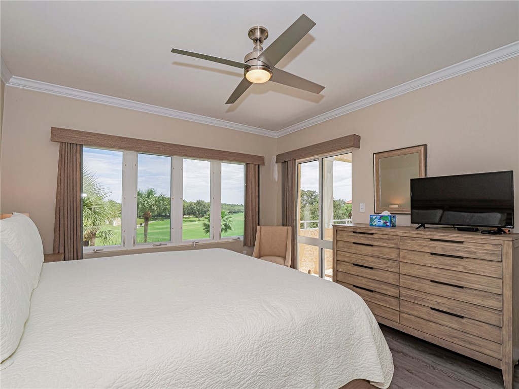 5060 Harmony Circle, Unit 304 Vero Beach, FL 32967 - Photo 20 of 36 a bedroom with a bed and a large window