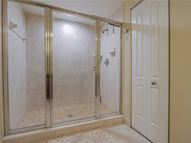 a bathroom with a glass shower door